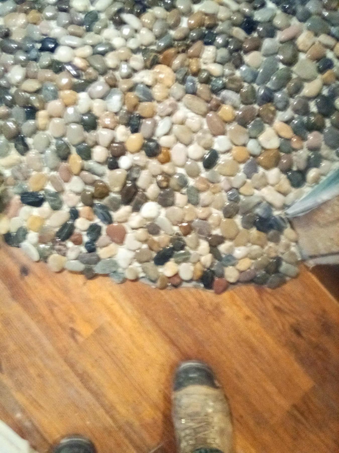 Close detail of the grouted river-rock floor.