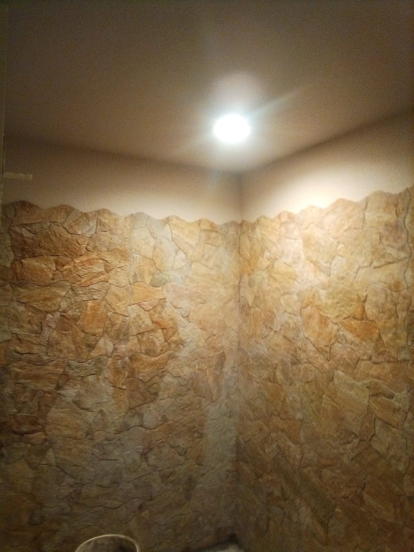 Stone wall panel turning the corner of the room.