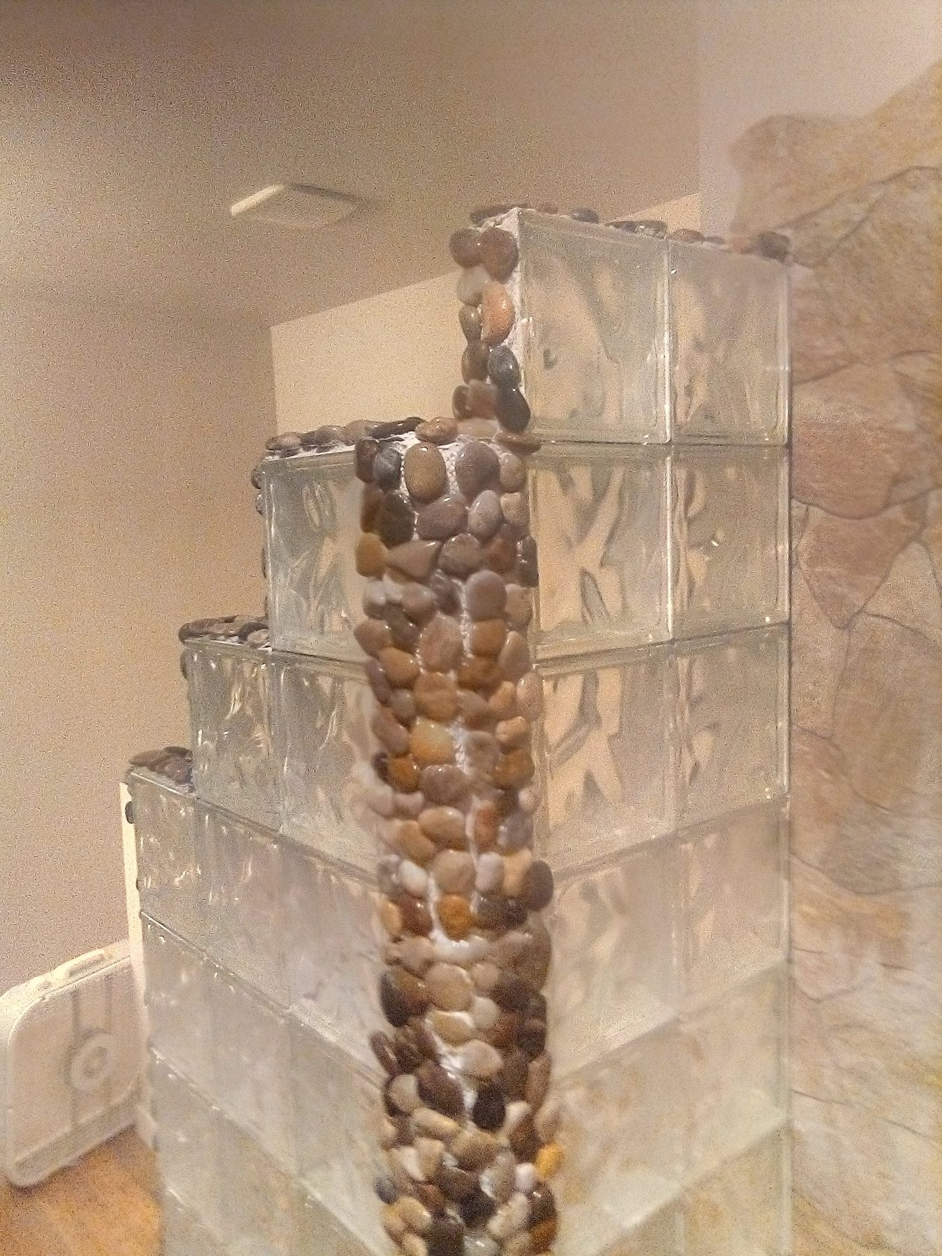 River-rock column detail running the full height of the wall.