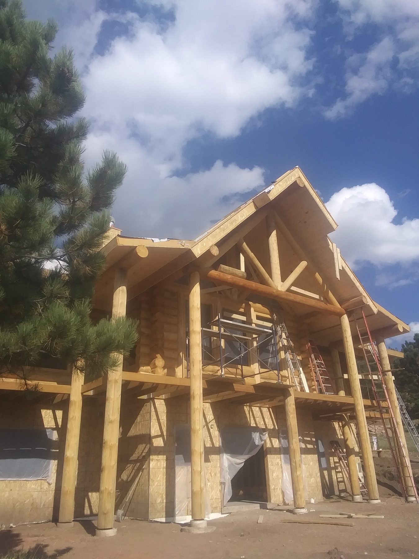 The building from the drive, roof complete and walls closed in.