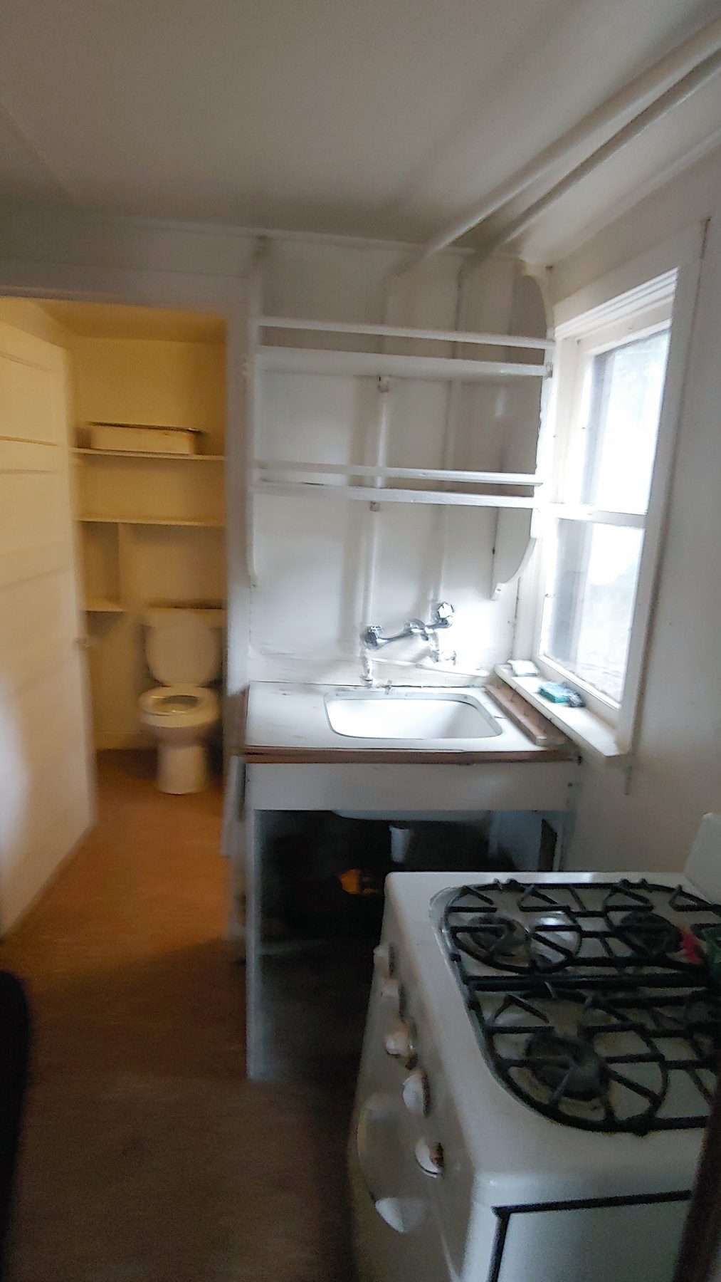 Before: the original kitchen with freestanding range.