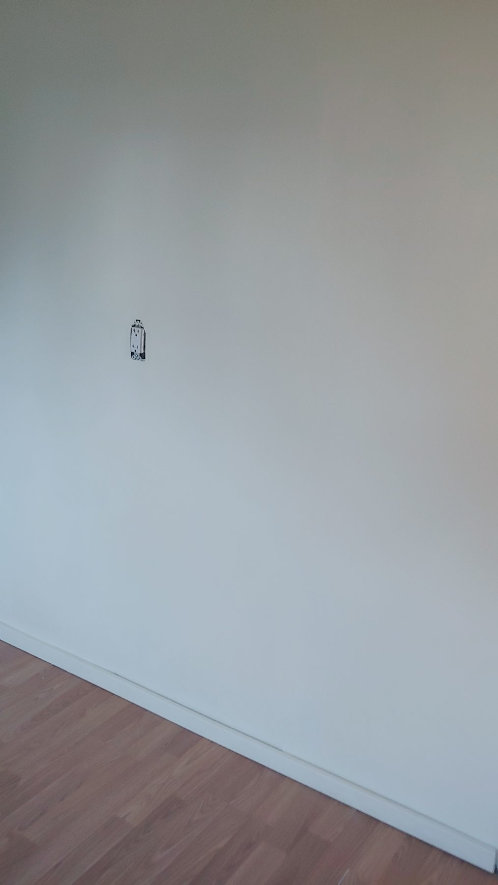 After: repainted room with new flooring throughout.