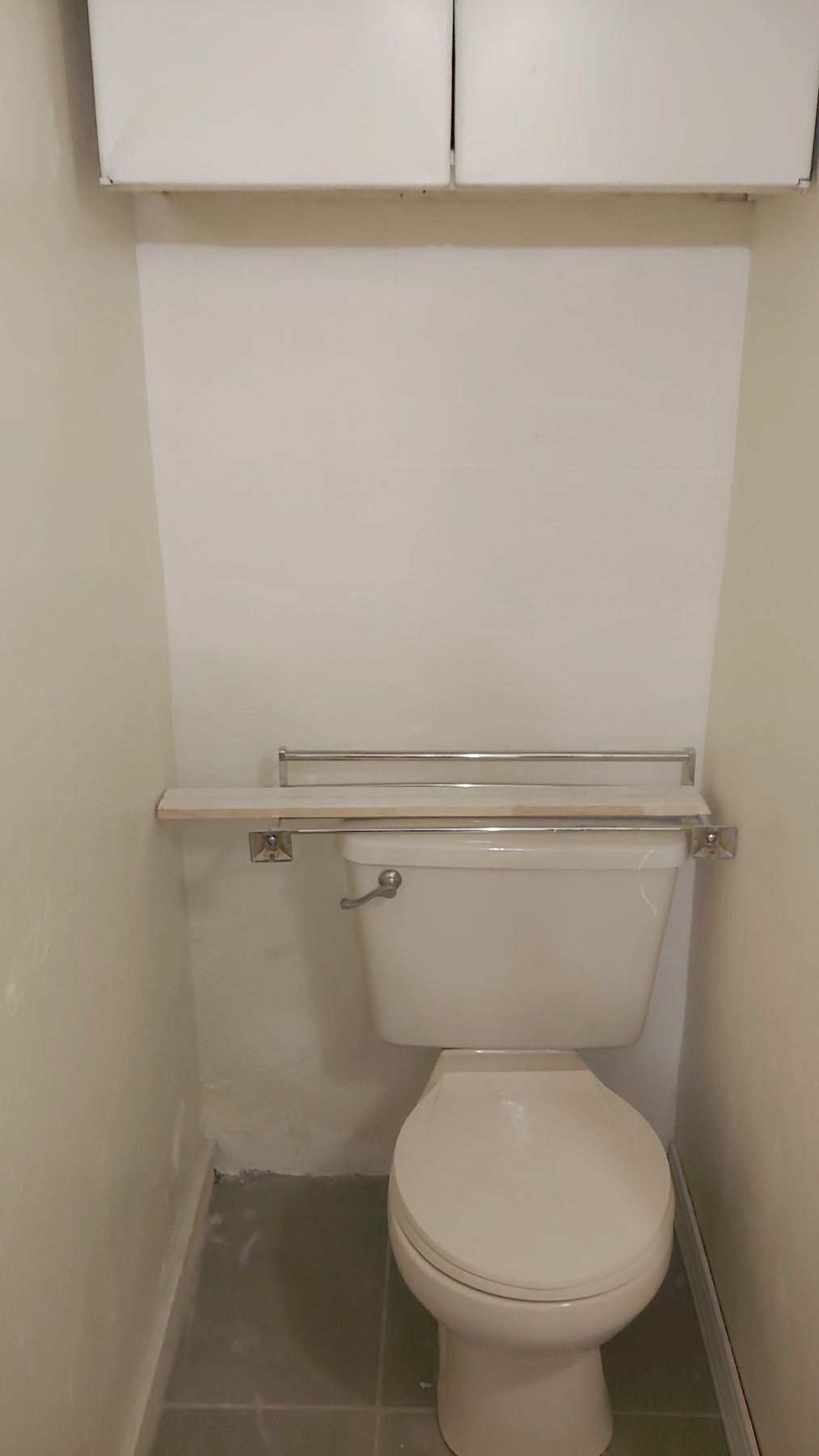 After: new toilet and tiled niche.